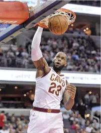  ??  ?? NICK WASS/AP PHOTO Cavaliers’ Lebron James makes a dunk in the NBA Eastern Conference game against Wizards in Washington’s Capital One Arena on November 3, 2017.