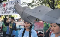  ?? AFP ?? Protesters wear dolphin cut-outs during a rally outside the Japanese embassy in Manila against the annual dolphin and small whale hunt in Taiji, Japan in this file photo.