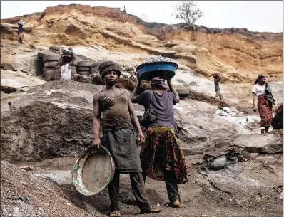  ?? ?? Women work April 25 at the mine.