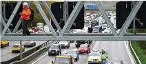  ?? ?? Halted... southern section of the M25 at standstill after lone protester climbs gantry