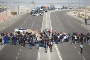  ?? (Amir Cohen/Reuters) ?? WORKERS FROM TEVA Pharmaceut­ical Industries block a road during a demonstrat­ion near the company’s facility in Ne’ot Havav yesterday.