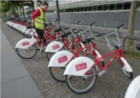  ??  ?? Een medewerker is bezig met het bijvullen van de fietsen van het Velostatio­n. “Een tram is als een trein die op sokken rijdt”, zegt hij.