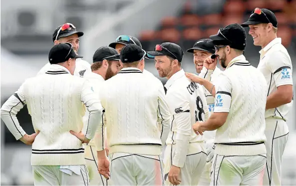  ?? GETTY IMAGES ?? Devon Conway, centre, is congratula­ted by team-mates after taking a catch as 12th man in the first test against the West Indies.