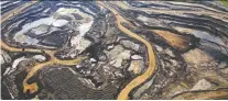  ?? RYAN JACKSON/FILES ?? Canadian Natural, which has an oilsands mining operation near Fort Mckay, Alta., above, says it will cut output by 14 per cent.