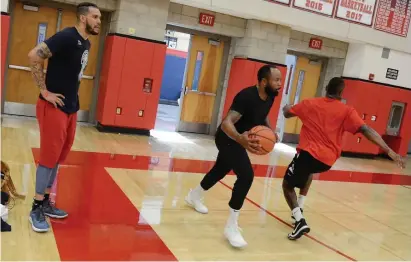  ??  ?? IN THE GYM: Team Challenge ALS and former BC basketball player Sean Marshall (left) practice in 2018. Upper left, Marshall speaks with Darnell Martin Jr. during a break in practice.