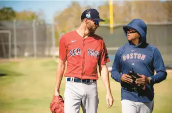  ?? BILLIE WEISS/BOSTON RED SOX/GETTY IMAGES ?? Sox starter Chris Sale talks with former pitcher Pedro Martinez during a spring training workout on Feb.22 in Fort Myers, Fla.