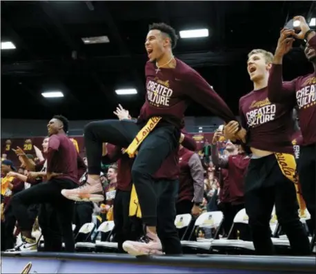  ?? ARMANDO L. SANCHEZ/CHICAGO TRIBUNE VIA AP ?? Loyola Ramblers guard Marques Townes, center, celebrates with other Loyola men’s basketball players after the team was selected to play in the NCAA Tournament during a selection show watch party at Gentile Arena on Sunday, March 11, 2018 in Chicago.