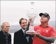  ?? Michael Macor / The Chronicle ?? With Clint Eastwood, left, and Jim Nance watching over, Ted Potter Jr., right, hoists the AT&T Pebble Beach Pro-Am championsh­ip trophy on Sunday.