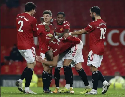  ??  ?? Manchester United celebrate after Scot McTominay (bent over) scored their sixth goal last night