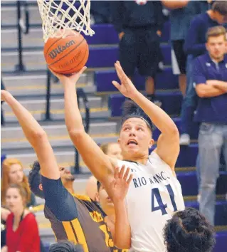  ?? JIM THOMPSON/JOURNAL ?? Forward Derrick Reyes of Rio Rancho goes up for a shot during Rio Rancho’s overtime win over Cibola on Thursday night. Reyes was strong inside, finishing with 13 points.