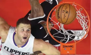  ?? MARK J. TERRILL/THE ASSOCIATED PRESS ?? Blake Griffin of the Clippers — battling under the rim against the Nets — is back to racking up monster numbers and has found an enviable balance on and off the court: “I’m just happy — happy with where I’m at.”