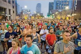  ?? TOM MCCARTHY JR. FOR AMERICAN-STATESMAN 2017 ?? The crowd stands for the national anthem before the start of the 2017 Austin Marathon and Half Marathon.
