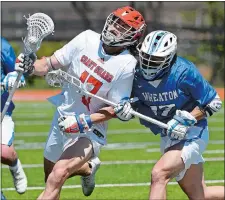  ?? DANA JENSEN/THE DAY Visit theday.com to view a photo gallery. ?? Coast Guard’s Logan Tobias (47) is checked by Wheaton’s Tyler Brown-Ortiz (17) during Saturday’s NEWMAC men’s lacrosse tournament semifinal in New London. The Bears earned a trip to the final with a 20-4 win.