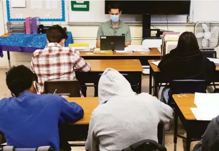  ?? Photos by Jessica Christian / The Chronicle ?? Social studies instructor Benjamin Hake teaches an English class at San Lorenzo High School as districts struggle to fill spots.