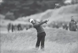  ?? DAN MULLAN, GETTY IMAGES ?? Rory McIlroy of Northern Ireland hits his second shot from the rough on the 13th hole Friday.