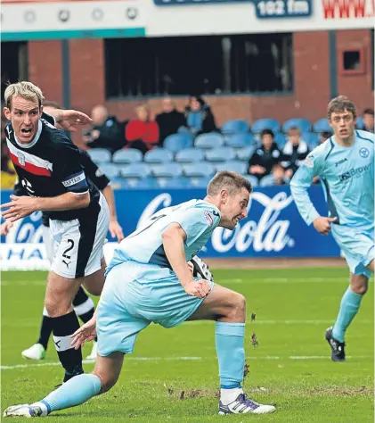  ?? SNS. ?? Steven MacLean scores against Dundee at Dens in 2012 on one of his first starts for Saints.