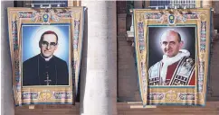  ?? ALESSANDRA TARANTINO/ASSOCIATED PRESS ?? Tapestries of Roman Catholic Archbishop Oscar Romero, left, and Pope Paul VI hang from a balcony of St. Peter’s Basilica at the Vatican.