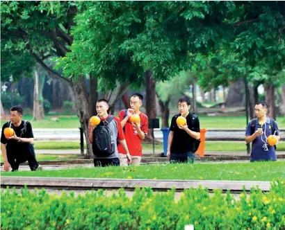  ??  ?? File picture of Chinese tourists enjoying coconut water at a local park. China is Sri Lanka's second largest tourism source market.