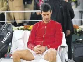  ?? (Photos: afp) ?? Serbia’s Novak Djokovic reacts at the end of the men’s final tennis match against winner, Spain’s Rafael Nadal at Philippe Chatrier court on day 15 of The Roland Garros 2020 French Open tennis tournament in Paris, yesterday.