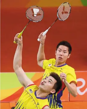  ??  ?? On the losing side: goh V Shem (right) and tan Wee Kiong playing against Fu Haifeng and Zhang nan of China in the doubles final match of the 2016 Olympics in Rio de Janeiro.