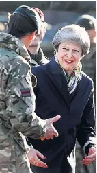  ??  ?? UNDER FIRE PM meets troops yesterday