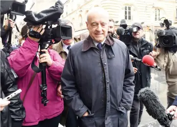  ??  ?? Juppe (front) being surrounded by journalist­s as he arrives at the City Hall to give a press conference in the western French city of Bordeaux. — AFP photo