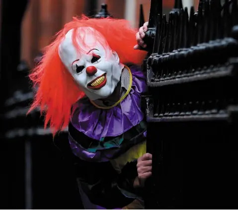  ??  ?? FREAK SHOW: Pranksters dressing up as creepy clowns to frighten unsuspecti­ng onlookers has become a global phenomenon