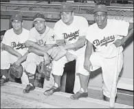  ?? AP file photo ?? Pitcher Don Newcombe (second from right) won rookie of the year, Most Valuable Player and Cy Young awards while helping teammates Roy Campanella (far left) and Jackie Robinson, as well as Larry Doby of the Cleveland Indians, integrate the league. Newcombe, 92, died Tuesday after a lengthy illness.