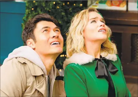  ?? Jonathan Prime Universal Pictures ?? K AT E (Emilia Clarke), an elf in a Christmas shop, meets Pollyanna-perfect Tom (Henry Golding) to a George Michael soundtrack.