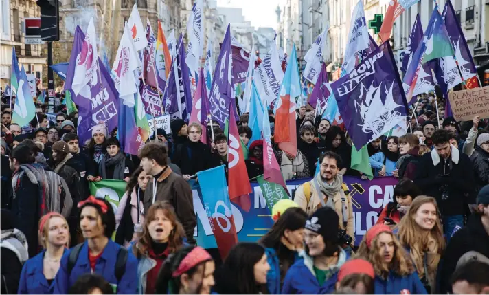  ?? ?? Protestors wave flags during a rally, called by left-wing La France Insoumise (LFI) party and Youth organizati­ons, to protest against the French President's pension reform, in Paris. Photo AP/Lewis Joly
