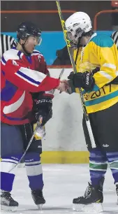  ??  ?? Scott Howe exchanges gifts with the captain of the North Korean national team following the second game of the March 2017 Pyongyang Ice Hockey League event.