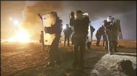  ??  ?? French policemen secure the migrants’ camp in Calais. REUTERS