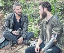  ?? GENE PAGE AMC ?? A possible romantic relationsh­ip between Jesus (Tom Payne, left) and Aaron (Ross Marquand) went unexplored on The Walking Dead, much to fans’ dismay.