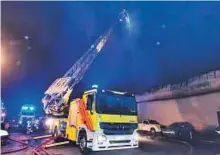  ?? Courtesy: Dubai Civil Defence ?? Firefighte­rs battle the blaze at two warehouses in Al Quoz Industrial Area 3 on Tuesday night.