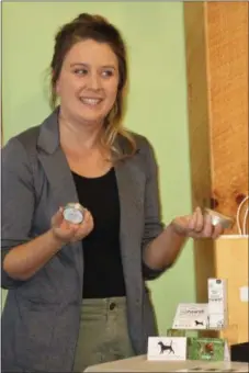  ??  ?? Rebecca Lawson, a sales associate for Charlotte’s Web products, showcases the hemp infused balm which features beneficial botanicals to help support healthy-looking skin and beautifica­tion according to the company website.