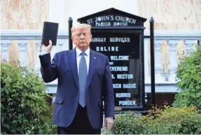  ?? PATRICK SEMANSKY/AP ?? Trump held up a Bible in June during a photo op outside St. John’s Church, where a fire was set during Black Lives Matter protests.