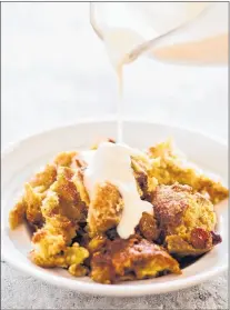  ?? DANIEL J. VAN ACKERE/AMERICA’S TEST KITCHEN VIA AP ?? New Orleans bourbon bread pudding with bourbon sauce appears in the cookbook “Cooking At Home With Bridget and Julia.”