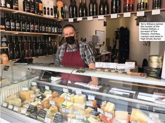  ??  ?? Terry Williams behind the counter at the Cheese Station, a purveyor of fine cheeses, chutneys, crackers and wines in High Street, Burton