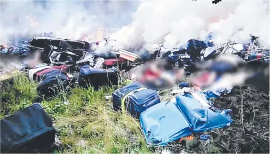  ??  ?? BODY SEARCH: A video image of the scene after the downing of Malaysia Airlines Flight MH17 one year ago today.