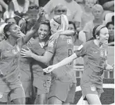  ?? FRANCK FIFE/GETTY ?? U.S. players celebrate during their semifinal win over England on Tuesday.