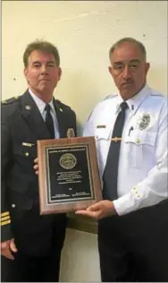  ?? GINGER RAE DUNBAR — DIGITAL FIRST MEDIA ?? West Chester Police Chief Scott Bohn and Lt. Samuel Iacono hold the District Attorney’s Commendati­on, presented by Chester County District Attorney Tom Hogan.