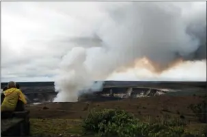  ?? The Associated Press ?? EXPLOSIVE SITUATION: Steam and gas rise from Kilauea’s summit crater on Wednesday in Volcanoes National Park, Hawaii. Geologists warned Wednesday that Hawaii’s Kilauea volcano could erupt explosivel­y and send boulders, rocks and ash into the air around...