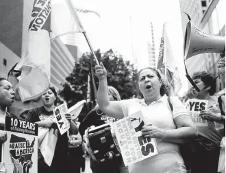  ?? Mark Mulligan / Houston Chronicle ?? Maria Ventura, who works as a janitor in downtown, rallies with other members of her union in front of One Allen Center in advance of a vote for a new contract.