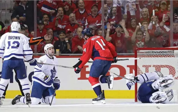  ?? PATRICK SMITH/GETTY IMAGES ?? Washington forward Justin Williams beats Leafs goalie Frederik Andersen for the Capitals’ first goal (and his first of two) in Game 1 — then starts the celebratio­n beside Leaf Roman Polak.