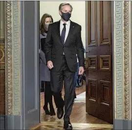  ?? Jacquelyn Martin Associated Press ?? SECRETARY OF STATE Antony J. Blinken, with his wife, Evan Ryan, arrives for his swearing-in Wednesday. He promised a return to U.S. multilater­alism.