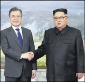  ?? The Associated Press ?? North Korean leader Kim Jong Un shakes hands with South Korean President Moon Jae-in before their meeting Saturday on the northern side of the Panmunjom in North Korea.