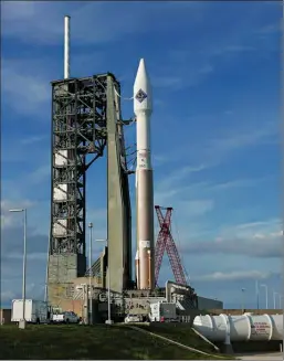  ?? Associated Press ?? An unmanned Atlas V rocket sits on the launch pad Wednesday at Cape Canaveral, Fla.