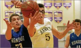  ?? TANIA BARRICKLO — DAILY FREEMAN ?? Rondout’s Jeremy Pugliese and Rhinebeck’s Zach Matthews reach for a loose ball during the Hawks’ victory in a game played in Rhinebeck, N.Y.