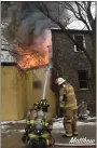  ?? PHOTO COURTESY OF MATTHEW B. BEATTY, NORTH PENN VOLUNTEER FIRE COMPANY ?? Firefighte­rs battle flames at a building fire at Main Street and West Butler Avenue in Ambler on Thursday.