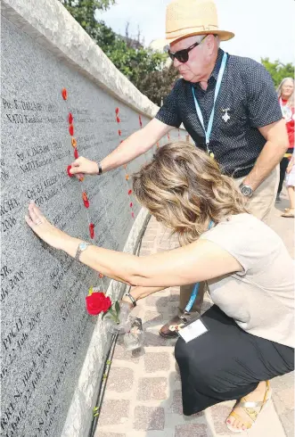  ?? PHOTOS: JIM WELLS ?? Mel and Helen Keller lay a flower and a poppy in honour of their son, the late Cpl. Bryce Keller, during Peacekeepe­rs Day on Sunday. Cpl. Keller was killed in Afghanista­n in August 2006 at age 27.